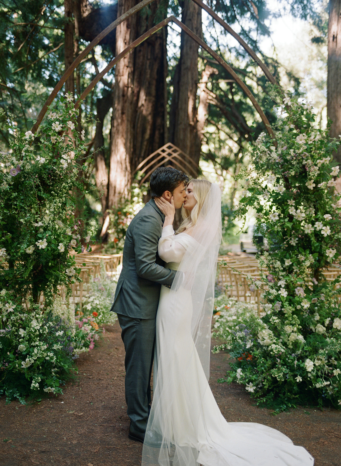 wedding couple kissing in a forest